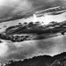 Japanese aircraft can be seen in the air above Pearl Harbor (top