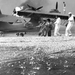 Sailors at Naval Air Station (NAS) Kaneohe attempt to salvage a 