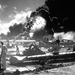 Sailors stand among wrecked airplanes at Ford Island Naval Air S