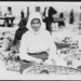 Woman with basket in market, Hungary 1923