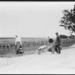 Man and two women, walking to market, with produce, Hungary