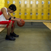 Sad basketball player in locker room